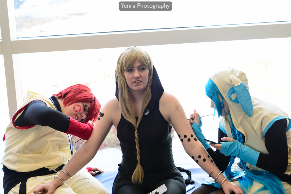 Cosplayers helping cosplayer at Tekko 2013