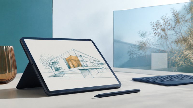 A tablet showing an architectural sketch rests on a stand beside a stylus and separate keyboard.